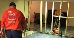 Water Damage Technicians Cleaning Carpet After A Flood